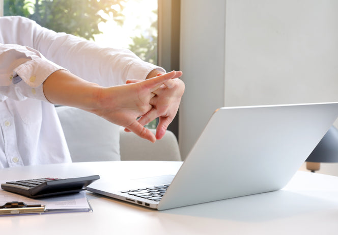 professional office worker stretching arms and hands