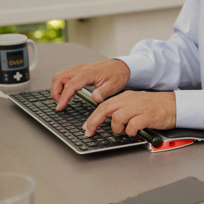 man using a rollermouse red plus and balance keyboard